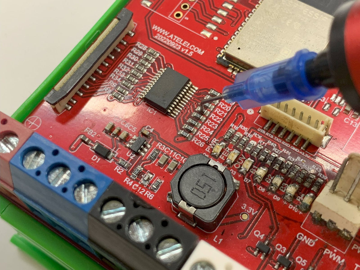 Angled needle placing a chip on a densely populated board