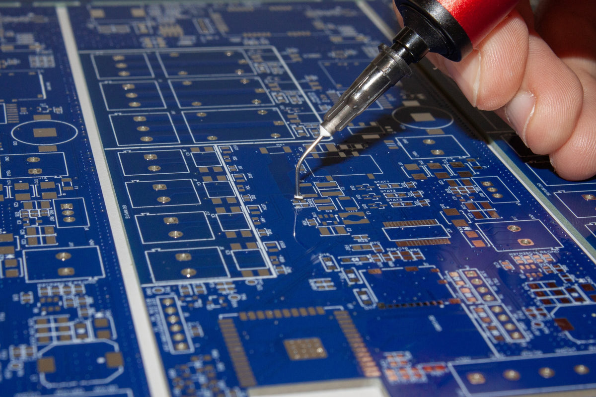 Picograb needle tip over a blue PCB
